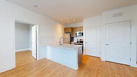 Located at 1001 W Elizabeth Ave in Linden, NJ, this 2-bedroom, 2-bathroom residence is thoughtfully designed to maximize functionality and comfort across a single floor. Light wood-style flooring runs throughout the entire space, lending a warm, cohesive feel to every room.

The open-concept living, dining, and kitchen area serves as the heart of the home. The kitchen is outfitted with stainless steel appliances — including a refrigerator, electric range, and built-in microwave — complemented by warm-toned cabinetry, a white subway tile backsplash, and a large center island with a stone-look countertop and undermount sink, ideal for both meal prep and casual dining.

Both bedrooms feature soft gray accent walls, large windows with blinds that invite natural light and outdoor views of the surrounding neighborhood, and individual wall-mounted HVAC units for personalized climate control. The primary bedroom offers a comfortable footprint with ample space.

The two bathrooms are finished with light gray shaker-style vanities, white quartz countertops, large mirrors, and wood-style flooring. The unit also includes in-unit laundry, four closets for generous storage, and a hallway that connects all spaces efficiently. Clean white walls and modern finishes create a bright, contemporary ambiance throughout.
