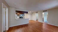 Located at 4470 S Lemay Ave in Fort Collins, CO, this 2-bedroom, 3-bathroom single-floor residence offers a well-organized layout with a comfortable, functional design throughout. The open-concept living and dining area is anchored by warm hardwood-style flooring and features a distinctive arched passageway leading to a bright windowed nook with a ceiling fan and built-in shelving — an ideal spot for reading or a home office setup. The kitchen is positioned behind a peninsula counter with granite-look surfaces, rich dark-wood cabinetry, and stainless steel appliances including a range, microwave, and refrigerator, making it both practical and visually appealing. The two bedrooms are carpeted for comfort, with the primary bedroom offering a dedicated walk-in closet equipped with built-in shelving and hanging rods. The secondary bedroom features a natural light-filled window. Three bathrooms serve the residence, including one with a full tub-shower combo finished in clean white tile. Textured ceilings are consistent throughout, and neutral wall tones create a cohesive, move-in-ready atmosphere. The floor plan flows efficiently, connecting all rooms with ease and offering ample storage via two closets.