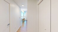 This contemporary apartment in Baltimore offers a blend of style and functionality across its 750 square feet. The open-concept living area seamlessly combines the kitchen and living room, creating an ideal space for both relaxation and entertainment. The kitchen boasts sleek white cabinetry, stainless steel appliances, and a convenient island, perfect for casual dining or food preparation.

Large windows flood the space with natural light and provide breathtaking views of the Baltimore waterfront and cityscape. The primary bedroom, measuring 130 square feet, offers ample space and continues the apartment's modern aesthetic. Two additional bedrooms provide versatility for guests, a home office, or personal use.

Both bathrooms feature clean lines and neutral tones, with one showcasing a combination tub-shower and the other a glass-enclosed shower. The apartment's hardwood floors throughout add warmth and elegance to the space. Despite its compact size, clever design elements maximize storage and create a sense of spaciousness.

This single-floor apartment effortlessly combines urban living with comfort, making it an ideal home for those seeking a contemporary lifestyle in the heart of Baltimore.