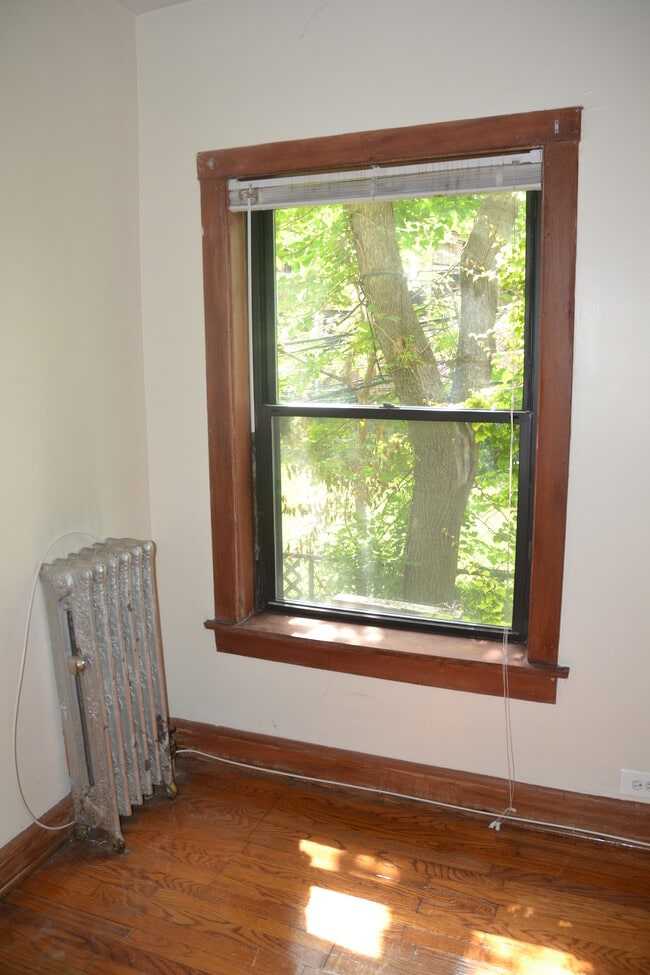 Bedroom looks out over quiet green spaces - 3518 N Broadway St