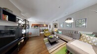 Located at 4650 N Rainbow Blvd in Las Vegas, Nevada, this one-bedroom, one-bathroom unit offers a well-designed, single-floor layout that maximizes every square foot of its compact footprint. The open-concept main living area seamlessly connects the living room, dining space, and kitchen, creating an airy and functional environment. Rich wood-style flooring flows throughout the main living areas, adding warmth and visual continuity.

The living room is generously sized, featuring neutral gray walls, large windows with vertical blinds that invite natural light, and ample space for a full seating arrangement. The kitchen is equipped with rich cabinetry in a warm wood tone, gas range, built-in microwave, refrigerator, and granite-style countertops, with a window that adds additional brightness to the cooking space.

The bedroom is a comfortable retreat, finished with plush carpeting, soft neutral walls, and a window dressed with sheer curtains. The full bathroom features a rich wood-toned vanity, large mirror with overhead lighting, and wood-style tile flooring. Additional practical spaces include a dedicated hallway, a closet for storage, and an in-unit laundry area, rounding out this efficiently planned Las Vegas residence.
