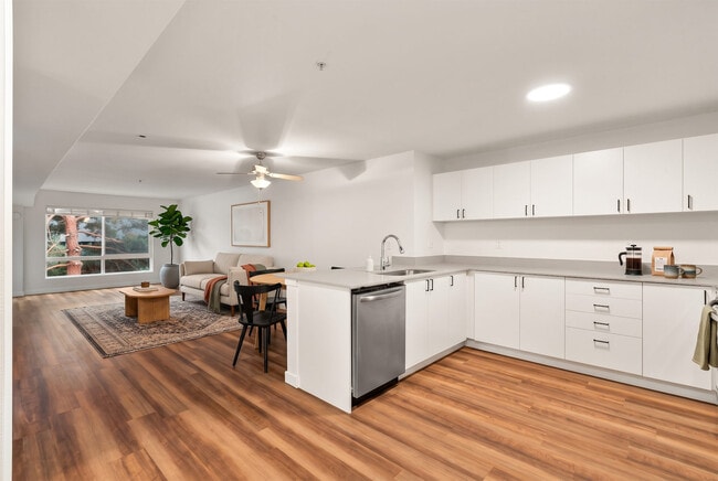 A full wraparound counter run gives you real prep space, with the dining area and living room just steps away. - The Baxter