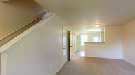 Located at 5555 Tinkey Park in Columbus, Ohio, this two-floor residence offers a functional and well-organized layout designed for comfortable everyday living. The interior features warm, neutral tones throughout, with light-colored walls and carpeted flooring that create a cozy and inviting atmosphere.

The main level showcases an open flow between living areas, with a staircase providing access to the second floor. The space includes multiple doorways leading to closets and additional rooms, offering ample storage and versatility. A kitchen area is visible toward the rear of the main level, featuring overhead lighting and a counter-height peninsula or bar that separates it from the adjoining living space. Natural light filters in through windows, brightening the interior and enhancing the overall sense of openness.

Flush-mounted ceiling fixtures provide consistent, even illumination throughout the hallways and common areas. The clean, uncluttered design of the space makes it highly adaptable to a variety of furnishing styles and personal preferences. The two-floor configuration adds a clear separation between living and private spaces, contributing to a well-structured and practical floor plan well-suited for residents of Columbus, OH.