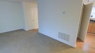 Located at 209 W Lockhaven Dr in Goldsboro, North Carolina, this two-story home offers a straightforward and functional layout suited for comfortable everyday living. The interior features neutral-toned walls throughout, creating a clean and versatile backdrop that adapts easily to a variety of décor styles. Carpeted flooring is present in the living areas, providing a soft and warm underfoot feel. The HVAC system is served by floor-level vents integrated into the walls, ensuring efficient climate control throughout the home. Door frames and baseboards are finished in crisp white, contributing to a tidy, cohesive look across the space. The transition between rooms is open and accessible, with connecting hallways that allow for easy movement between living areas. Spanning two floors, the home provides separation between living and private spaces, a practical feature for households seeking defined zones for daily activity and rest. The overall ambiance is modest and move-in ready, with a neutral palette that makes it easy for new occupants to settle in and make the space their own. This home represents a solid, unpretentious option in the Goldsboro area.