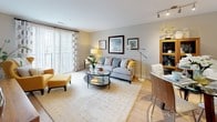 This single-floor residence at 553 S Commercial in Manchester Street offers a thoughtfully designed layout that balances comfort and functionality. The living area is a welcoming space finished with light hardwood-style flooring and neutral walls, bathed in natural light streaming through large sliding glass doors fitted with patterned drapes. The room accommodates both a lounging and media area, with track lighting overhead adding flexible illumination. Views to the surrounding streetscape are visible through the expansive windows.

The kitchen features warm wood cabinetry paired with stainless steel appliances, including a refrigerator, range, and microwave. A generous island with a crisp white countertop provides additional workspace and casual dining potential, while recessed lighting keeps the space bright and practical.

The bedroom is carpeted and serene, with a large window allowing natural light and outdoor views. It connects to what appears to be a dedicated dressing or bathroom area through paneled white doors, offering a sense of separation and privacy.

The bathroom is finished in neutral tones with large-format floor tiles, white cabinetry, a wide vanity with an undermount sink, and a tub-shower combination with a decorative curtain. The overall ambiance throughout is clean, modern, and move-in ready.