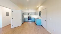 Located at 201 River St in Santa Cruz, CA, this efficiently designed one-bedroom, one-bathroom residence offers a thoughtfully laid-out single-floor plan. Light wood-toned flooring runs throughout, creating a cohesive and airy feel across every room.

The kitchen is a standout feature, showcasing a two-tone cabinet design with soft blue lower cabinets and gray upper cabinets, paired with clean white countertops. Stainless steel appliances — including a gas range, microwave, and dishwasher — provide full functionality, while recessed lighting and a window with blinds add brightness and ventilation.

The open living area adjoins the kitchen seamlessly, offering flexible use of space. A wall-mounted mini-split unit ensures climate control year-round.

The bedroom is a well-proportioned, quiet retreat with a window that invites natural light and a view of the surroundings. A large sliding-door closet with tall panel doors maximizes storage while maintaining a clean, modern aesthetic.

The bathroom is finished with marble-style tile surrounding a soaking tub and shower combination, complemented by a light vanity with blue cabinetry and dark hardware accents, continuing the design language seen throughout the home.

Overall, this residence offers a clean, modern interior with cohesive finishes and practical amenities in a central Santa Cruz location.