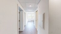 Located at 400 S 40th St in Philadelphia's University City neighborhood, this two-bedroom, one-bathroom unit offers a well-designed, single-floor layout with a clean, contemporary aesthetic throughout.

The kitchen is a standout feature, showcasing two-tone cabinetry with crisp white upper cabinets and slate-blue lower cabinets, complemented by white quartz countertops, a white subway tile backsplash, and stainless steel appliances including a refrigerator, built-in microwave, and dishwasher. Large windows flood the kitchen and dining area with natural light and views of surrounding greenery.

Both bedrooms feature wood-style flooring and bright, neutral walls with windows overlooking the outdoors. The primary bedroom benefits from added height, mirrored sliding closet doors, and direct sightlines to the bathroom and second bedroom. The second bedroom is equally well-lit, with a baseboard heating system and a serene garden view.

The bathroom is thoughtfully finished with classic white hexagonal tile flooring, a white vanity with a framed mirror, and a full shower-tub combination. A connecting hallway links all rooms efficiently, contributing to the unit's functional and cohesive flow. Light wood-style flooring runs consistently throughout, unifying the space with a warm, modern feel.