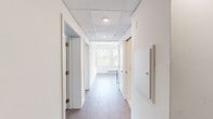 Located at 400 S 40th St in Philadelphia's University City neighborhood, this two-bedroom, one-bathroom unit offers a well-designed, single-floor layout with a clean, contemporary aesthetic throughout.

The kitchen is a standout feature, showcasing two-tone cabinetry with crisp white upper cabinets and slate-blue lower cabinets, complemented by white quartz countertops, a white subway tile backsplash, and stainless steel appliances including a refrigerator, built-in microwave, and dishwasher. Large windows flood the kitchen and dining area with natural light and views of surrounding greenery.

Both bedrooms feature wood-style flooring and bright, neutral walls with windows overlooking the outdoors. The primary bedroom benefits from added height, mirrored sliding closet doors, and direct sightlines to the bathroom and second bedroom. The second bedroom is equally well-lit, with a baseboard heating system and a serene garden view.

The bathroom is thoughtfully finished with classic white hexagonal tile flooring, a white vanity with a framed mirror, and a full shower-tub combination. A connecting hallway links all rooms efficiently, contributing to the unit's functional and cohesive flow. Light wood-style flooring runs consistently throughout, unifying the space with a warm, modern feel.