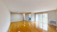 Located at 192 Capricorn Dr in Hillsborough, NJ, this single-floor, 3-bedroom, 2-bathroom residence offers a practical and comfortable layout with consistent design throughout. Polished hardwood floors run through the living areas and bedrooms, lending warmth and a cohesive aesthetic to the entire space.

The living room is generously sized and filled with natural light, thanks to large sliding glass doors that open to an outdoor view of lush greenery. Baseboard heating is present throughout, ensuring year-round comfort. The open sightline from the living room into the kitchen creates an easy, connected flow.

The kitchen features warm wood cabinetry, granite-style countertops, and a full suite of stainless steel appliances including a refrigerator, dishwasher, range, microwave, and oven, all illuminated by a skylight overhead and complemented by light vinyl flooring.

The primary bedroom is notably spacious, offering room for substantial furnishings, and benefits from multiple windows that frame outdoor green views. The two additional bedrooms are well-proportioned with the same hardwood flooring and natural light. Both bathrooms are functional and clean, featuring wood-framed vanity mirrors and light-toned fixtures. The overall ambiance of the residence is bright, neutral, and move-in ready.