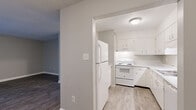 Located at 800 Academy Lane in Columbia, TN, this single-floor unit offers three bedrooms, three bathrooms, and a practical, well-organized layout. The combined living and dining area features wood-look plank flooring and a sliding glass door dressed with vertical blinds, filling the space with natural light and providing direct access to a private outdoor patio. The kitchen is fully equipped with white cabinetry, ample counter space, a double-basin sink, an electric range, and a refrigerator — all finished in a clean, all-white palette with light wood-look flooring. A central hallway connects the main living areas to the three bedrooms, each carpeted for comfort and featuring closet storage. The primary bedroom includes its own dedicated closet with built-in shelving. The three bathrooms are consistently finished with white vanities, mirrored medicine cabinets, and brushed nickel fixtures, with one featuring a tub/shower combination. Additional spaces include a dedicated laundry area, a utility room, and four closets distributed throughout for generous storage. Neutral gray walls and white trim carry a cohesive, clean aesthetic throughout the entire unit.