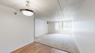 Located at 20965 Lahser Rd in Southfield, Michigan, this two-bedroom, two-bathroom single-floor residence offers a practical and well-laid-out living space. The open living and dining area is a defining feature, combining wood-look flooring in the dining zone with plush carpeting in the living area, all beneath a textured ceiling. A pendant light fixture anchors the dining space, while a large window with vertical blinds fills the living area with natural light and outdoor views.

The kitchen features warm wood-toned cabinetry — both upper and lower — paired with light countertops, a stainless steel sink, and wood-look flooring. A narrow pantry cabinet provides additional storage.

Both bedrooms are carpeted and generously sized, each equipped with windows that bring in natural light. The primary bedroom includes direct access to one of the two bathrooms and features a louvered sliding closet. With four closets total throughout the unit, storage is plentiful. The bathrooms are clean and functional, with one featuring a glass-enclosed shower.

Two hallways connect the rooms efficiently, contributing to a smooth and logical flow throughout. The textured ceilings are consistent across the space, lending a cohesive aesthetic to this comfortable Southfield residence.