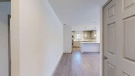 Located at 1970 Peachford Rd in Dunwoody, GA, this well-designed two-bedroom, two-bathroom residence offers a thoughtfully organized single-floor layout. The open-concept living, dining, and kitchen area forms the heart of the home, creating a bright and seamless space ideal for both daily living and entertaining. The kitchen is a standout feature, equipped with stainless steel appliances, gray shaker-style cabinetry, a subway tile backsplash, granite countertops, a central island with pendant lighting, and a dedicated sink with a window view. Wood-look flooring flows consistently throughout the entire residence, lending a clean and cohesive aesthetic. The primary bedroom features a tray ceiling with a ceiling fan, a sliding door with vertical blinds, and direct access to a walk-in closet. The second bedroom also includes a tray ceiling and ample natural light. Both bathrooms are finished with white subway tile tub-and-shower surrounds and granite vanity tops. Additional spaces include a dedicated laundry area, entrance foyer, hallway, and three closets providing generous storage. The overall ambiance is modern, neutral, and move-in ready.