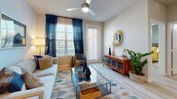 Located at 18313 FM 1093 in Richmond, TX, this thoughtfully designed one-bedroom, one-bathroom residence offers a comfortable and modern living experience across a single floor. Light-toned wood-style flooring flows seamlessly throughout the space, lending warmth and cohesion to every room.

The open-concept kitchen and living area forms the heart of the home. The kitchen is outfitted with stainless steel appliances, including a full-size refrigerator, range, microwave, and dishwasher. Two-tone cabinetry in white and slate gray pairs with granite countertops and a functional island with a single-basin sink, offering both style and practicality. Pendant lighting accents the space above.

The living room receives abundant natural light through large windows dressed with shutters and drapes, and features a ceiling fan overhead. A private exterior door adds convenience and connectivity to the outdoors.

The bedroom is a serene retreat highlighted by a teal accent wall, large windows, a ceiling fan, and direct access to the walk-in closet, which features built-in shelving and hanging rods for generous storage.

The bathroom impresses with a dual-sink granite vanity, framed mirrors, and a full soaking tub with tile surround, completing this well-appointed residence.