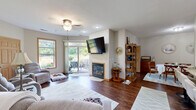Located at 625 Shepherd Ct in Brookfield, WI, this well-appointed single-floor home offers 2 bedrooms, 3 bathrooms, a dedicated office, and a thoughtfully designed layout. The open living room serves as a central gathering space, featuring rich hardwood flooring, a gas fireplace, a ceiling fan, and sliding glass door access to a private outdoor patio with scenic greenery views. The combined kitchen and dining area is a functional highlight, showcasing rich cherry cabinetry, granite countertops, stainless steel appliances, and a breakfast bar with seating. Adjacent to the kitchen, the formal dining room provides an intimate setting with warm hardwood floors. The office is a versatile flex space with a ceiling fan, hardwood floors, and a window overlooking the outdoors. Both bedrooms are carpeted and bright, with the primary bedroom offering a generously sized picture window framing lush outdoor views. Three bathrooms include tiled finishes throughout. Five closets provide ample storage, and a dedicated laundry room adds everyday convenience. Neutral tones, wood-trimmed windows and doors, and recessed lighting lend a cohesive, comfortable feel throughout this Brookfield home.
