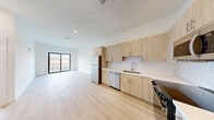 Located at 475 SW 27th Ave in Fort Lauderdale, FL, this thoughtfully designed 2-bedroom, 2-bathroom residence offers a clean, modern aesthetic throughout its efficiently utilized single-floor layout. Light-toned luxury vinyl plank flooring flows seamlessly through the open-concept living, dining, and kitchen areas, creating a bright and airy atmosphere. The kitchen is well-appointed with light wood cabinetry, white quartz countertops, a white subway tile backsplash, and a full suite of stainless steel appliances including a refrigerator, dishwasher, range, and built-in microwave. The open layout connects directly to the living and dining areas, which extend to a private balcony through a floor-to-ceiling sliding glass door offering outdoor views. The primary bedroom features direct balcony access and ample natural light, while the second bedroom includes a black-framed window overlooking the exterior. Each bedroom is finished with the same light flooring and neutral white walls. The primary bathroom offers a frameless glass walk-in shower with beige tile surround, while the second bathroom features a tiled tub-shower combination. A dedicated in-unit laundry area houses a full-size front-loading washer and dryer. Additional features include a utility room, closet, and recessed lighting throughout.