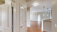Located at 500 Providence Main St NW in Huntsville, Alabama, this well-appointed 2-bedroom, 2-bathroom residence offers a thoughtfully designed single-level layout. Warm wood-look flooring flows throughout the main living areas, complemented by neutral tones and ceiling fans that create a comfortable, cohesive atmosphere. The open-concept kitchen and living area serves as the heart of the home, featuring rich espresso cabinetry, granite countertops, a classic subway tile backsplash, and a full suite of stainless steel appliances. Pendant lighting accents the kitchen, while the adjoining living room benefits from natural light and direct access to an outdoor area through a glass door. Both bedrooms are generously proportioned, carpeted for comfort, and equipped with ceiling fans and large windows that invite ample natural light. Each bedroom is served by its own closet, including a spacious walk-in with wire shelving for organized storage. The bathrooms are finished with tile flooring and dark vanity cabinetry with granite-style countertops, and each includes a tub-shower combination. A dedicated laundry room with side-by-side washer and dryer connections and wire shelving adds practical convenience to this well-rounded residence.