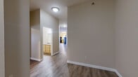 Located at 411 N 42nd St in Grand Forks, ND, this well-appointed 3-bedroom, 2-bathroom single-floor home offers a thoughtfully designed layout with generous living space throughout. The open-concept area seamlessly integrates the living room, dining room, and kitchen, creating a bright and functional hub for daily living. The kitchen is equipped with light wood cabinetry, dark granite-style countertops, and black appliances including a range, microwave, and refrigerator, all complemented by durable wood-look flooring and windows that invite natural light. The living and dining areas continue the wood-look flooring and feature a curved architectural detail that adds a distinctive character to the space. The primary bedroom is generously sized, featuring plush carpeting, a ceiling fan, and a built-in closet. Additional bedrooms also offer carpet flooring, natural light from windows, and baseboard heating. Both bathrooms are finished with light wood vanities, granite-style countertops, and tub-shower combinations. A dedicated in-unit laundry room houses a full-size washer and dryer. With four closets distributed throughout, storage is plentiful. The neutral warm-toned walls and consistent finishes create a cohesive, inviting atmosphere throughout the home.