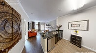 Located in Raleigh, NC, this thoughtfully designed one-bedroom, one-bathroom residence offers a comfortable and functional single-floor layout. Crown molding throughout lends a refined architectural touch, while wood-style flooring flows seamlessly through the main living areas.

The open-concept kitchen and living room serve as the heart of the home. The kitchen is outfitted with dark cabinetry, granite countertops, a tile backsplash, stainless steel appliances — including a refrigerator, dishwasher, and range — and a peninsula that provides additional prep and seating space. The living room receives natural light through large windows dressed with floor-length drapes, creating a warm and inviting atmosphere.

A dedicated dining room offers an intimate setting, complete with a pendant chandelier and ample wall space, connecting smoothly to the rest of the living areas.

The spacious primary bedroom features plush carpet, a ceiling fan, natural light from a window, and generous room to accommodate a large bed and additional furnishings. The full bathroom includes tile flooring, dark granite vanity, and a bathtub with shower combination, maintaining the consistent finishes found throughout the home.
