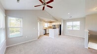 Located at 1499 Finger Lakes in Dayton, Ohio, this 2-bedroom, 1-bathroom home offers a well-designed single-floor layout with a generous amount of living space. The kitchen is a functional highlight, featuring white cabinetry, granite-look countertops, a central island, light wood-style flooring, and a full suite of stainless steel appliances including a dishwasher, range, microwave, and refrigerator. Track lighting and windows on multiple sides provide ample natural light throughout. The living area features vaulted ceilings, a ceiling fan, and a window overlooking the outdoors, creating a bright and airy atmosphere. Both bedrooms are carpeted in a neutral tone, offering comfortable and versatile spaces, each with closets and access to the hallway. The primary bedroom benefits from natural light filtering through its windows. The bathroom is equipped with a tub-shower combination, wood-style tile flooring, and clean, neutral finishes. A utility room and dedicated closet provide practical storage. One of the standout features of this home is the private deck, which offers sweeping views of a tranquil pond and lush green lawn, ideal for relaxing outdoors. The exterior showcases a brick and siding facade within a well-maintained community setting.