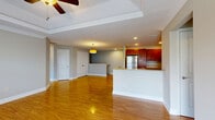 Located at 18 Stoneledge Dr in Troy, NY, this two-story, four-bedroom, two-bathroom home offers a well-organized and comfortable layout across two floors. The main level features a combined kitchen and living room area, where the kitchen stands out with rich cherry wood cabinetry, granite countertops, stainless steel appliances including a refrigerator, range, microwave, and dishwasher, and light tile flooring. The living area flows naturally from the kitchen and is highlighted by warm hardwood flooring and a tray ceiling with a ceiling fan, creating an open and inviting atmosphere with ample natural light. A full bathroom on this level features tile flooring, a granite-topped vanity, and a glass-enclosed shower. The staircase leads to the upper floor, where the majority of the living space resides. The generously sized primary bedroom is a standout feature, boasting a tray ceiling with a ceiling fan, multiple windows for natural light, and plush carpeting. Additional bedrooms on this floor are finished with soft carpeting, crown molding, and closet space. A carpeted hallway connects the upper rooms, and a second full bathroom with tile flooring and a granite vanity serves this level. The home's clean, neutral palette and consistent finishes throughout create a cohesive and move-in ready environment.