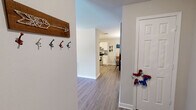 Located at 1000 Spring Lake Blvd in Byram, Mississippi, this single-story 2-bedroom, 3-bathroom home offers a well-organized layout across a comfortable footprint. Wood-look plank flooring flows throughout the main living areas, complemented by neutral wall tones that create a bright, cohesive atmosphere. The living room features a ceiling fan, large windows that invite natural light, and an open feel with direct access to the rest of the home, including a dedicated laundry room equipped with a full-size washer and dryer and overhead shelving. The kitchen is appointed with white cabinetry, a stainless steel range, dishwasher, and ample counter space, and it opens directly to a charming dining room adorned with chair rail molding and an elegant chandelier. Three full bathrooms serve the home, each featuring white vanity cabinetry and wood-look flooring; one includes a tub-shower combo. The two bedrooms are carpeted for comfort and each includes a ceiling fan and closet. The primary bedroom is generously sized with a dedicated en-suite bathroom featuring a spacious vanity. A separate closet room adds additional storage convenience. This home provides practical, well-appointed living in a single-level design.