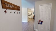 Located at 1000 Spring Lake Blvd in Byram, Mississippi, this single-story 2-bedroom, 3-bathroom home offers a well-organized layout across a comfortable footprint. Wood-look plank flooring flows throughout the main living areas, complemented by neutral wall tones that create a bright, cohesive atmosphere. The living room features a ceiling fan, large windows that invite natural light, and an open feel with direct access to the rest of the home, including a dedicated laundry room equipped with a full-size washer and dryer and overhead shelving. The kitchen is appointed with white cabinetry, a stainless steel range, dishwasher, and ample counter space, and it opens directly to a charming dining room adorned with chair rail molding and an elegant chandelier. Three full bathrooms serve the home, each featuring white vanity cabinetry and wood-look flooring; one includes a tub-shower combo. The two bedrooms are carpeted for comfort and each includes a ceiling fan and closet. The primary bedroom is generously sized with a dedicated en-suite bathroom featuring a spacious vanity. A separate closet room adds additional storage convenience. This home provides practical, well-appointed living in a single-level design.