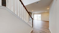 Located at 331 Walden Way in Middletown, PA, this three-bedroom, three-bathroom home spans three floors, offering generous living space across each level. The main floor features an open-concept kitchen and living area, where the kitchen stands out with white shaker cabinetry, granite countertops, a large island with a built-in sink, stainless steel appliances, and pendant lighting. The living room is anchored by a sleek fireplace set against a contemporary accent wall, with a sliding glass door providing access to an outdoor balcony and filling the space with natural light. Hardwood-style flooring runs throughout the main level. The upper floor houses the bedrooms, each carpeted and featuring closets — including a walk-in closet in at least one room. The bathrooms are finished with white vanities, granite countertops, chrome fixtures, and hardwood-style flooring. The generously sized primary bedroom includes a private ensuite bath. An attached garage with an automatic opener offers convenient parking and storage. The lower level is an expansive, unfinished basement with concrete floors, exposed framing, a water heater, and an electrical panel — presenting significant potential for future customization or additional living space.