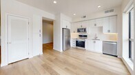 Located at 3150 S Highland Dr in Millcreek, Utah, this efficiently designed single-floor unit offers a clean, contemporary aesthetic throughout. Light-toned hardwood flooring runs continuously across the entire space, creating a cohesive and airy feel.

The kitchen is a standout feature, outfitted with crisp white shaker-style cabinetry, a white subway tile backsplash, and a full suite of stainless steel appliances including a refrigerator, electric range, built-in microwave, and dishwasher. Recessed lighting illuminates the workspace, which also includes a stainless steel sink. The kitchen opens directly to the main living area, promoting an open and functional layout.

The living area benefits from large floor-to-ceiling windows that flood the space with natural light and frame scenic mountain views — a notable feature that adds character and depth to the compact footprint.

The bathroom is well-appointed with a tiled tub-and-shower combination, a warm wood-toned vanity, built-in open shelving for storage, and consistent hardwood-style flooring. Two hallways provide practical circulation and access throughout the unit.

Overall, the space presents a modern, move-in-ready interior with thoughtful finishes, efficient use of space, and appealing natural views of the surrounding Wasatch landscape.