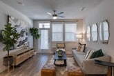 Located at Vintage Preserve Parkway in Houston, TX 77070, this single-story residence offers a thoughtfully designed open-concept layout finished with consistent wood-style flooring across the main living areas. The living room serves as the heart of the unit, featuring a ceiling fan, neutral wall tones, and large windows with blinds that allow ample natural light. A glass-panel exterior door further connects the living space to the outside. The dining area sits adjacent to the living room, creating a seamless flow ideal for everyday living and entertaining.

The kitchen is well-equipped with dark-toned shaker-style cabinetry extending to the ceiling for substantial storage, a white tile backsplash, light stone countertops, and a full suite of stainless steel appliances including a side-by-side refrigerator with ice and water dispenser, electric range, and over-the-range microwave.

Both bedrooms are carpeted and generously sized, each featuring ceiling fans and windows with blinds providing natural light. The primary bedroom connects to a well-appointed en suite bathroom showcasing dark wood cabinetry, granite countertops with an undermount sink, a glass-enclosed walk-in shower with subway tile, and hardwood-style flooring. The layout also includes closet space accessible from the bathroom hallway.