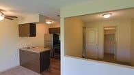 This single-story space is designed with a functional, open layout that connects the kitchen and living areas seamlessly. The kitchen is outfitted with dark wood cabinetry that provides ample storage, paired with a light-toned countertop that extends into a breakfast bar — an ideal feature for casual dining or additional prep space. Stainless steel appliances, including a refrigerator and a gas range, lend a modern touch to the cooking area. A sink is integrated into the countertop near the bar, enhancing the kitchen's practicality. The flooring in the kitchen area consists of dark hardwood-style planks, offering a contrast to the lighter carpeted zones visible in adjacent areas. A textured ceiling adds dimension throughout the space. A pass-through window opening in the wall connects the kitchen to a hallway beyond, where a paneled interior door and neutral-toned walls create a clean, understated aesthetic. The overall color palette — warm taupes, dark wood accents, and light green-tinted walls — gives the space a cozy yet straightforward character suited to everyday living.
