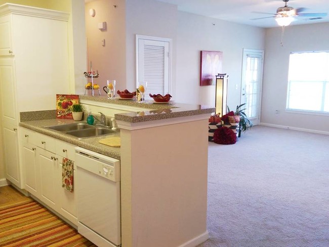 Kitchens feature a breakfast bar overlooking the living room. - Pine Lake