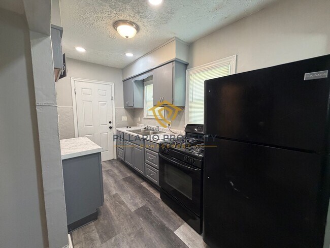 Building Photo - Charming 3-Bedroom Stone Bungalow with 2-Car Detached Garage & Fenced Yard, Available NOW!