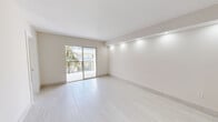 Located at 1355 W 44th Pl in Hialeah, FL, this thoughtfully designed 2-bedroom, 2-bathroom residence offers a bright and contemporary living experience across a well-organized single floor. Light-toned large-format tile flooring runs consistently throughout the space, creating a seamless and airy aesthetic.

The living room is an open, inviting area enhanced by recessed accent lighting along a structural beam and sliding glass doors that lead to a private balcony, offering views of the surrounding neighborhood and tropical greenery. The galley-style kitchen is outfitted with crisp white shaker cabinetry, sleek quartz countertops, stainless steel hardware, and modern appliances, maximizing both storage and functionality.

Both bedrooms are generously proportioned, filled with natural light from large windows, and finished with the same neutral tile flooring. The primary bedroom includes a closet for added convenience. Each of the two bathrooms is finished with floor-to-ceiling white subway tile in the walk-in showers, brass-toned fixtures, mosaic tile shower floors, and modern vanities — giving each bathroom a clean, spa-inspired feel. A hallway connects the rooms efficiently, completing a practical and polished layout throughout.