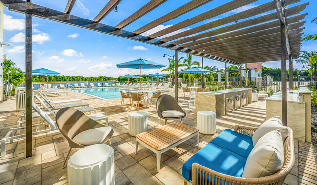 Relax poolside with friends and family. - The Reserve at Coconut Point