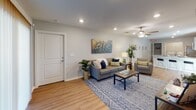 This single-story unit in Spartanburg, South Carolina, offers a thoughtfully designed layout with multiple bedrooms, bathrooms, a fully equipped kitchen, and a spacious living area. Warm wood-look flooring flows consistently throughout the space, creating a cohesive and inviting atmosphere.

The living room serves as the central gathering space, featuring recessed lighting, a ceiling fan, and sliding glass doors that admit generous natural light and provide outdoor access. Neutral gray walls complement the open feel of the room.

The kitchen is outfitted with stainless steel appliances, including a refrigerator, electric range, and over-the-range microwave. Gray cabinetry pairs with granite-style countertops, offering ample workspace and storage.

Each bedroom includes a ceiling fan, window blinds for light control, and comfortable proportions. The bedrooms maintain the same neutral palette found throughout the unit, contributing to a calm and restful environment.

The bathrooms feature tub-shower combinations with curtains, granite-style vanity countertops, wood-look flooring, and clean, understated finishes. Each bathroom is efficiently arranged and well-lit.

Overall, the space presents a clean, modern aesthetic with consistent finishes and functional design throughout.