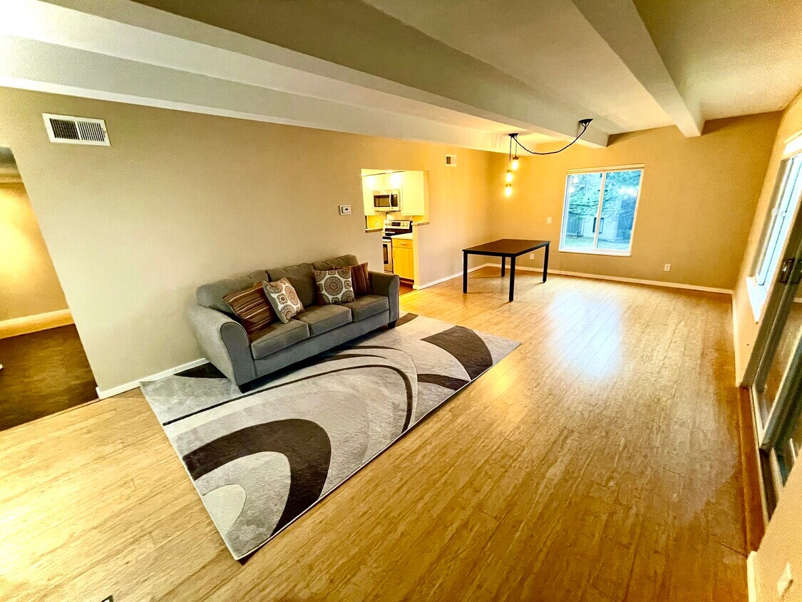 Open-concept living/dining room area is bright yet cozy - 2525 S Dayton Way
