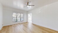 Located at 1229 S Central Ave in Glendale, CA, this one-bedroom, one-bathroom unit offers a clean and contemporary living experience on a single floor. The interior is unified by light-toned hardwood flooring that runs throughout the living and bedroom areas, creating a warm and cohesive aesthetic against the crisp white walls.

The living room is an open, airy space bathed in natural light from large windows dressed with horizontal blinds. A ceiling fan overhead adds both function and a modern touch. The room flows seamlessly toward the kitchen, making the layout feel connected and practical.

The kitchen is bright and well-appointed, featuring white shaker-style cabinetry, marble-look tile flooring, and sleek quartz countertops. Stainless steel appliances — including a gas range and microwave — provide a polished, functional workspace. A deep sink with a professional-style faucet rounds out the kitchen's refined details.

The bedroom is a comfortable, sunlit retreat with its own ceiling fan, natural light from a window, and the same warm wood flooring found throughout. The space is thoughtfully laid out to maximize usability.

The bathroom maintains the home's clean aesthetic with marble-look tile flooring, a white vanity with brushed nickel fixtures, a mirrored medicine cabinet, and a tub-shower combination — all in a bright, well-kept finish.