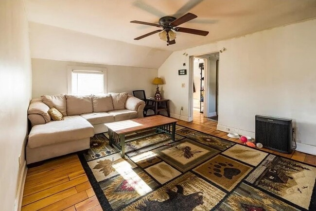 Living with original hardwood floors, ceiling fan, windows filled with natural light - 521 Bay St