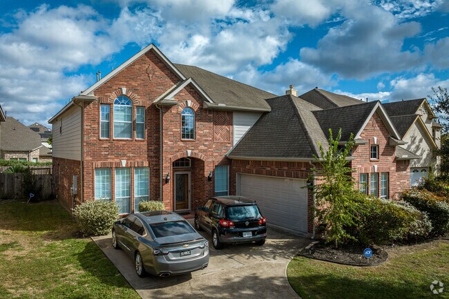 Traditional-style homes boast arched entryways in Rosenberg.