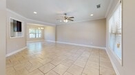 Located at 75 Shell Stone Ct in Pike Road, Alabama, this well-appointed single-story home offers a thoughtfully designed layout with a blend of comfort and modern finishes throughout. The open living and dining areas are finished with large-format light tile flooring, crown molding, recessed lighting, and ceiling fans, creating a bright and welcoming atmosphere. A chandelier adds an elegant touch to the dining space, which is bathed in natural light from a front-facing window. The kitchen is outfitted with rich dark espresso cabinetry, granite countertops, a classic white subway tile backsplash, and stainless steel appliances, including a dishwasher, all set atop the same light tile flooring. The bedrooms feature warm wood-look vinyl plank flooring, ceiling fans, and windows with blinds that allow for natural light and privacy. The bathroom showcases matching dark cabinetry with granite countertops and a glass-enclosed walk-in shower with tile surround. A dedicated laundry room includes upper dark cabinetry and washer/dryer connections. The attached two-car garage provides ample storage and parking space, completing this functional and stylish home.