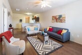 Located at 2610 Milwaukee Ave in Lubbock, Texas, this single-story residence offers a well-organized layout designed for comfortable, functional living. The open-concept living area serves as the heart of the home, featuring warm hardwood-style flooring, a ceiling fan, and generous wall space that lends itself to personalization. The space flows seamlessly into the kitchen, which is outfitted with dark espresso cabinetry, a full-size refrigerator, electric range, and over-the-range microwave — providing ample storage and all essential appliances for everyday cooking. A dedicated in-unit laundry area is conveniently accessible directly from the kitchen. The residence includes two bedrooms, each carpeted for comfort and featuring ceiling fans, natural light from windows with blinds, and enough room for standard furnishings. Two bathrooms serve the home, each featuring dark cabinetry for storage, wood-style flooring, and shower-tub combinations. The consistent use of neutral tones throughout the home creates a calm, cohesive aesthetic, while the practical single-floor layout ensures easy navigation between all areas of the space.