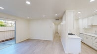 Located at 1505 De Rose Way in San Jose, California, this single-floor, 2-bedroom, 2-bathroom home offers a clean, modern aesthetic throughout. Light wood-look flooring and a neutral color palette create a bright, cohesive atmosphere across all rooms.

The open living area flows seamlessly into the kitchen, which features white shaker-style cabinetry, a gas range, light countertops, a sink with ample cabinet storage, and a window overlooking the exterior. Recessed lighting illuminates the space efficiently throughout.

A long hallway connects the living area to both bedrooms and bathrooms. The primary bedroom is a well-proportioned room with recessed lighting and an adjoining walk-in closet outfitted with dual clothing rods and built-in shelving on three walls. The second bedroom also benefits from recessed lighting and a window with views of surrounding greenery, bringing in natural light.

Both bathrooms are finished in a clean, white palette, each featuring a full tub-shower combination, a toilet, and a vanity with white cabinetry and a single sink. One bathroom includes an illuminated mirror above the vanity.

The home also includes a dedicated hallway and closet space, contributing to overall storage and functionality. The consistent finishes and layout make this a practical, well-organized residence in San Jose.