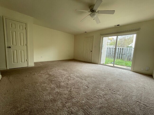 Living Room with Sliding Door to Fenced Backyard - 163 Jenness Ln