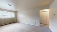 Located at 933 Wilmington Ave in Dayton, Ohio, this 2-bedroom, 1-bathroom unit offers a functional single-floor layout across a comfortable footprint. The living room greets you at the entrance with neutral carpet flooring, vertical blind-covered windows that invite natural light, and a ceiling fan for added comfort. A dedicated entryway with a front door mat transitions smoothly into the carpeted living space.

The kitchen is well-appointed with warm wood cabinetry, stone-look countertops, dark hardwood-style vinyl flooring, and black appliances including a full-size refrigerator and a stainless steel sink. An adjacent dining area provides a defined space for meals.

Both bedrooms feature plush carpeting, neutral wall tones, and windows with vertical blinds that allow for natural light and privacy. The primary bedroom offers a generous footprint, while the second bedroom also provides comfortable space. A closet adds practical storage.

The full bathroom includes a white tub and shower combination with built-in shelving niches, white tile surround, and standard fixtures. Additional spaces include a utility room and several unclassified rooms for flexible use. The overall aesthetic is clean, neutral, and move-in ready.