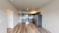 Located at 651 Osigian Blvd in Warner Robins, Georgia, this one-bedroom, one-bathroom unit offers a thoughtfully designed single-floor layout with consistent, modern finishes throughout. Light wood-look plank flooring runs seamlessly across every room, creating a clean and cohesive aesthetic.

The open-concept kitchen and living area serves as the heart of the unit. The kitchen is equipped with dark, shaker-style cabinetry, granite-look countertops, and a full suite of stainless steel appliances, including a refrigerator, electric range, and microwave. Recessed lighting adds warmth to the space.

The bedroom is a comfortable, well-lit retreat featuring two windows that allow ample natural light to fill the room. A ceiling fan provides additional comfort, and a wall-mounted mini-split unit ensures efficient climate control. The room opens to a dedicated closet outfitted with wire shelving for organized storage.

The bathroom features dark wood cabinetry with a granite-look vanity top, a soaking tub, and wood-look flooring that ties in with the rest of the unit. A hallway connects the living spaces to the private areas of the home. Neutral wall tones throughout lend a bright, move-in-ready feel to this practical and modern unit.