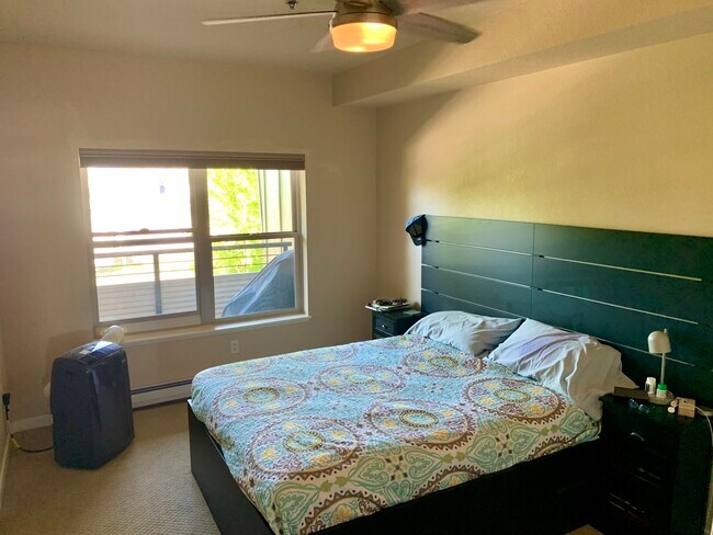 Queen bed, ceiling fan and portable air conditioner- Master bedroom. - 2101 Dearborn Ave