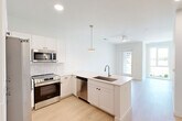 Located at 600 St Clair Ave SW in Huntsville, Alabama, this contemporary two-story residence offers three bedrooms and four bathrooms thoughtfully distributed across two well-proportioned floors. The main level centers on an open-concept living and kitchen area flooded with natural light. The kitchen is outfitted with crisp white shaker cabinetry, a subway tile backsplash, stainless steel appliances including a side-by-side refrigerator, electric range, built-in microwave, and dishwasher, all anchored by a peninsula with a undermount sink and light quartz countertops. Light wood-tone flooring flows seamlessly throughout both levels, complementing the clean white walls and modern aesthetic. A ceiling fan and recessed lighting enhance the living area's comfort and brightness. The upper floor houses the bedrooms, including a primary suite with an en-suite bathroom featuring illuminated vanity mirrors and ample cabinetry. Additional bathrooms are finished with tiled tub-shower combinations, light countertops, and wood-look flooring. Secondary bedrooms benefit from large windows that invite natural light and outdoor views of the surrounding neighborhood. Two staircases provide convenient circulation between floors, while dedicated closets and a hallway round out the efficient, well-designed layout. The overall ambiance is clean, bright, and move-in ready.