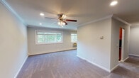 Located at 425 Main Street in Northport, NY, this single-floor residence at Fairfield Northport Village combines thoughtful design with practical finishes throughout. The spacious main living area is finished with plush carpeting, crown molding, and recessed lighting, while a ceiling fan adds comfort and style. Multiple windows frame views of lush greenery, flooding the room with natural light and creating a bright, welcoming atmosphere. Baseboard heating ensures year-round comfort.

The kitchen is well-equipped with rich wood cabinetry, dark granite countertops, a black tile backsplash, and stainless steel appliances including a range, microwave, and refrigerator. A washer unit is conveniently integrated into the kitchen space, and tile flooring adds a clean, durable finish.

The bedroom offers a serene retreat with carpeted floors, crown molding, a window overlooking the community grounds, and a generously sized double closet with built-in shelving and drawers for ample storage.

The bathroom is appointed with a tiled tub-and-shower combination enclosed by sliding glass doors, a granite vanity with an undermount sink, and a window for natural ventilation. Crown molding is carried throughout, lending a cohesive, polished character to the entire residence.