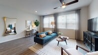 Located at 6701 W Farm to Market 1960 Rd in Houston, TX, this 1-bedroom, 1-bathroom unit offers a thoughtfully designed single-floor layout with contemporary finishes and a cohesive modern aesthetic throughout.

The living area is bright and welcoming, featuring large windows dressed with sheer curtains and blinds that allow generous natural light to fill the room. Wood-look flooring runs throughout, and a ceiling fan adds both style and functionality. The open layout connects seamlessly to a dedicated workspace area, making the living space as practical as it is comfortable.

The kitchen is well-equipped with crisp white cabinetry, granite countertops, a classic subway tile backsplash, and a full suite of stainless steel appliances including a side-by-side refrigerator, electric range, built-in microwave, and dishwasher. A peninsula with an undermount sink adds additional prep space and anchors the kitchen's clean, modern design.

The bedroom is a serene retreat, featuring a ceiling fan, soft neutral walls, and warm wood-look flooring. Decorative wall accents add character to the space.

The bathroom is elegantly finished with marble-look tile surrounding the soaking tub and shower, a granite-topped vanity with white cabinetry, and wood-look flooring. A walk-in closet is conveniently accessible from the bathroom, providing ample storage.