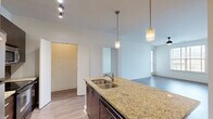 This well-appointed 3-bedroom, 3-bathroom single-floor residence at 390 Stovall St SE in Atlanta, Georgia offers a thoughtfully designed layout with modern finishes throughout. The open-concept kitchen serves as the heart of the home, featuring a granite-topped island with a double sink, dark cabinetry, a stylish blue tile backsplash, stainless steel appliances, and elegant pendant lighting — all flowing seamlessly into the living area. Hardwood-style flooring runs throughout the main living spaces, lending warmth and cohesion to the interior. The living room benefits from natural light through large windows, complemented by a ceiling fan for year-round comfort. Each bedroom offers a comfortable footprint, with the primary bedroom featuring direct access and ample natural light. Closet space is well-addressed, including a dedicated walk-in closet with wire shelving. The bathrooms are clean and functional, with at least one featuring a full soaking tub with classic white subway tile surround. A dedicated in-unit laundry area with a full-size washer and dryer adds everyday convenience. Track lighting and thoughtful ceiling fixtures provide flexible illumination throughout this practical and modern Atlanta residence.